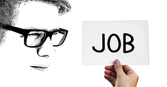 Man with glasses looking at a card with the word JOB written on it