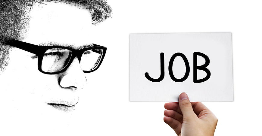 Man with glasses looking at a card with the word JOB written on it
