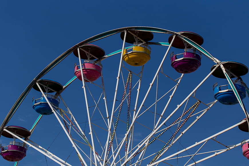 Colorful Ferris Wheel Against Blue Sky