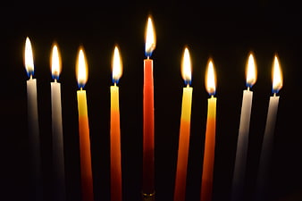 Hanukkah Menorah with Lit Candles on Black Background