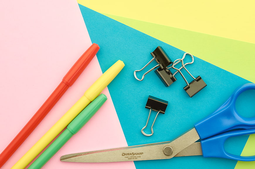 Colorful Office Supplies Flat Lay on Geometric Background