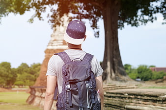 Backpacker Man Walking Towards Ancient Temple Ruins