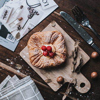 Overhead view of raspberry danish pastry on wooden board