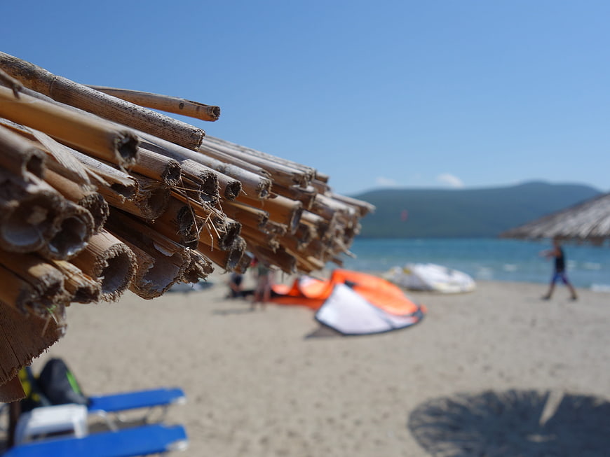 Close-up of bamboo beach umbrella with blurred summer sea background