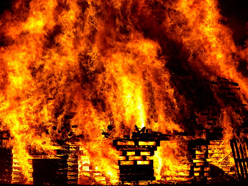 Intense Fire Burning Wooden Pallets at Night
