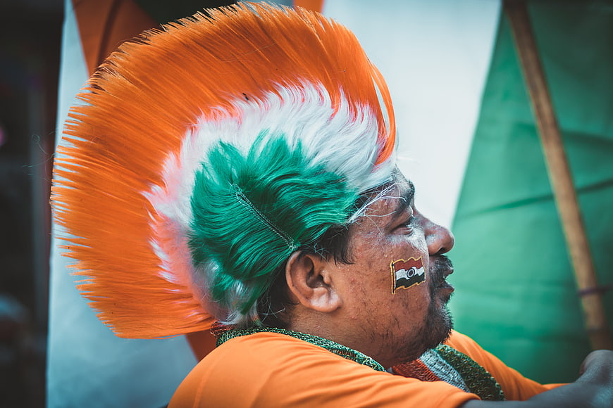 Indian man with tricolor mohawk and flag face paint