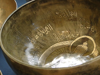 Close-up of Tibetan Singing Bowl with Buddha Engraving