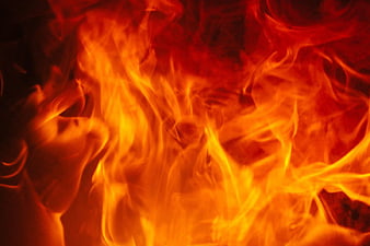 Close-up of intense orange and yellow flames burning