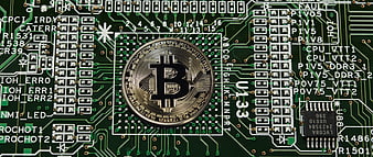 Bitcoin Coin Placed On Green Computer Motherboard Circuit Board