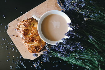 Overhead view of almond croissant and coffee with lavender