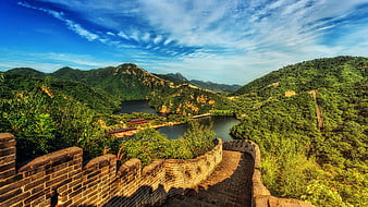 Great Wall of China overlooking a scenic mountain lake and green hills