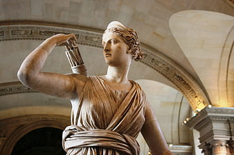 Ancient Greek Goddess Statue Holding Arrows in Museum Hall
