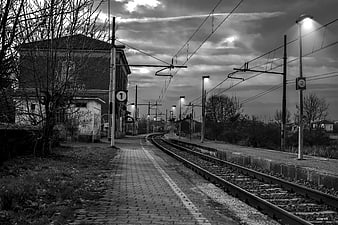 Empty Train Station Platform at Dusk with Overhead Wires