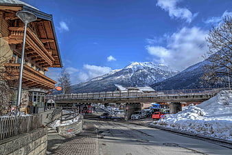 Snowy Alpine Village Street with Mountain View