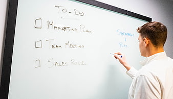 Man Writing To-Do List on Whiteboard