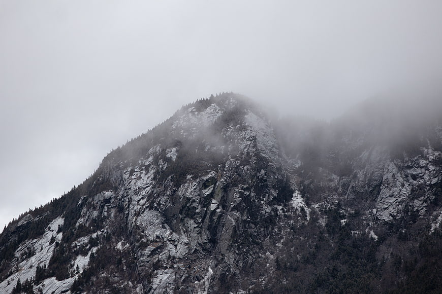 Misty Mountain Peak with Snow and Pine Trees