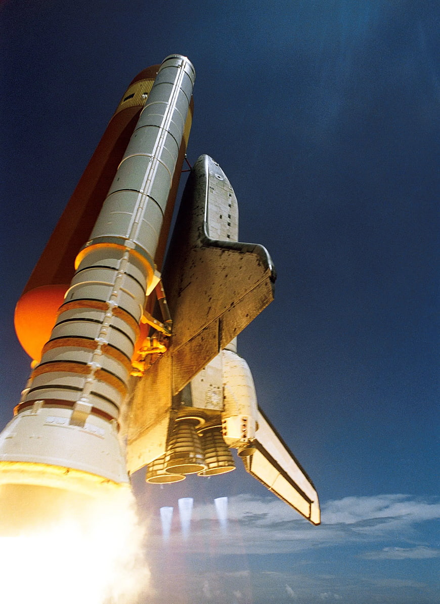 Space Shuttle Launching into Blue Sky with Solid Rocket Booster