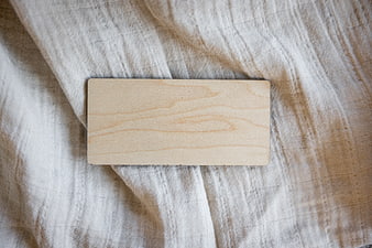 Blank wooden sign on textured linen fabric background