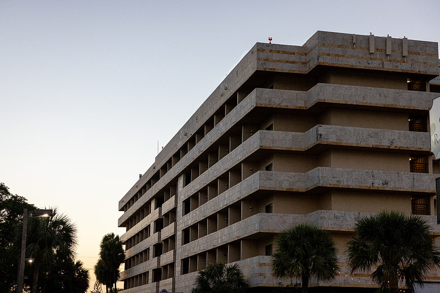 Modern Concrete Building Architecture at Dusk with Palm Trees