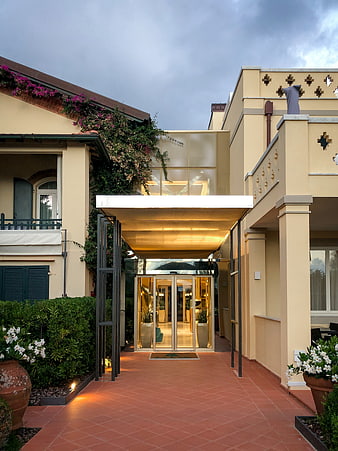 Modern Architectural Entrance With Terracotta Paving And Lush Greenery