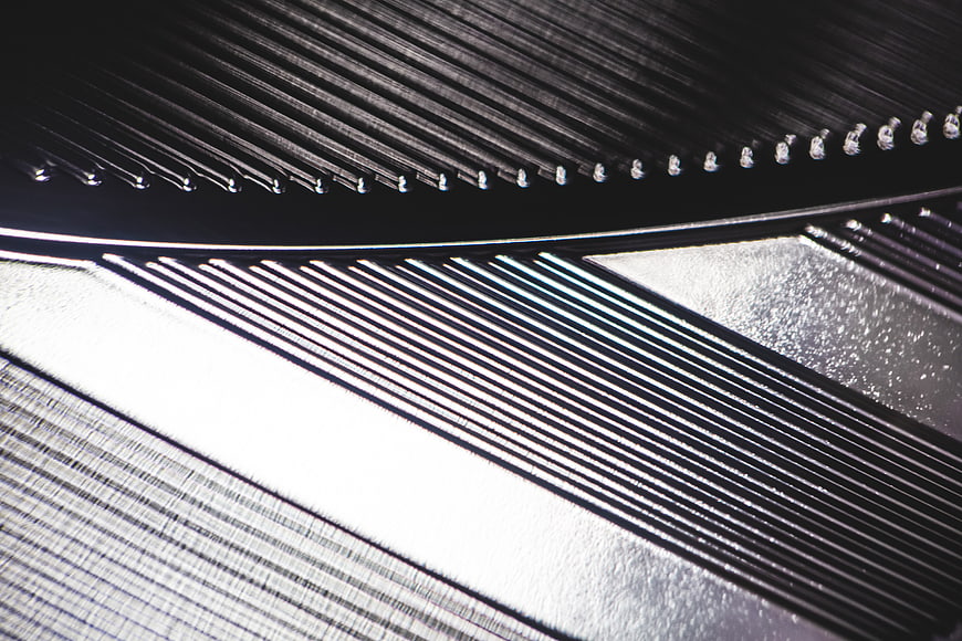 Abstract Macro Shot of Textured Metal Grating and Silver Surfaces