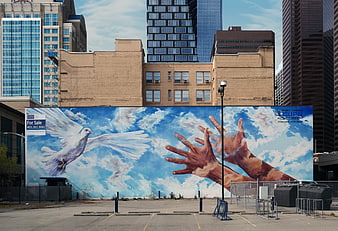 Urban Mural of Dove and Hands Reaching for Sky