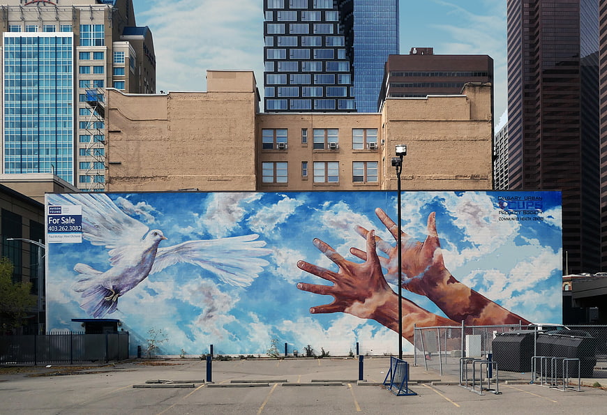 Urban Mural of Dove and Hands Reaching for Sky