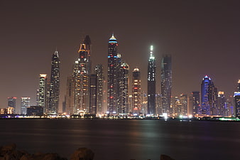 Dubai Marina skyline at night with illuminated skyscrapers