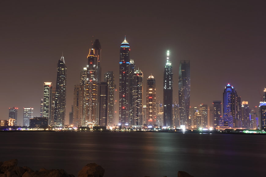 Dubai Marina skyline at night with illuminated skyscrapers