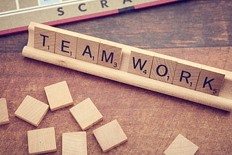 Wooden Scrabble Tiles Spelling Teamwork on Rack