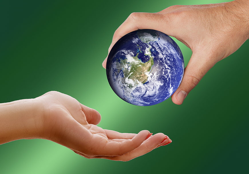 Hands Passing Globe Symbolizing Environmental Responsibility