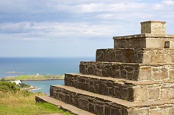 Stone Pyramid Steps Overlooking Ocean Coastline