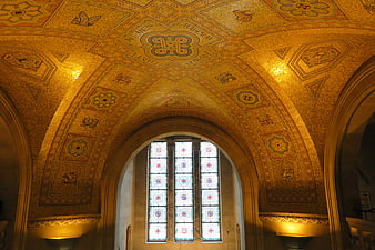 Ornate Byzantine gold mosaic ceiling with stained glass window