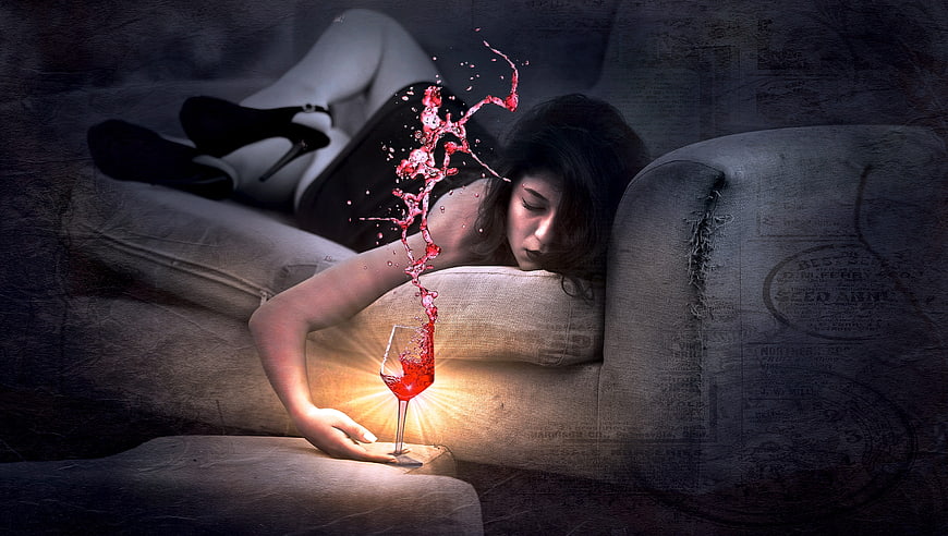 Woman sleeping on sofa with glowing red wine splash