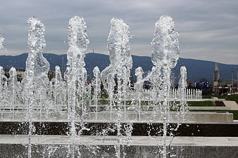 Frozen Water Jets In Urban Fountain With Zagreb Cityscape Background