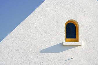 Minimalist White Wall With Yellow Arched Window And Blue Sky