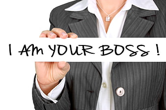 Businesswoman holding sign saying I am your boss