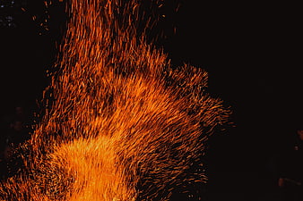 Dramatic Orange Sparks Flying Against Black Night Background