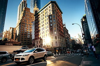 Sunlit New York City Street Corner with Skyscrapers and Traffic