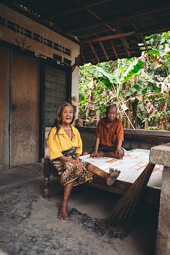Elderly Couple Sitting on Porch in Rural Village