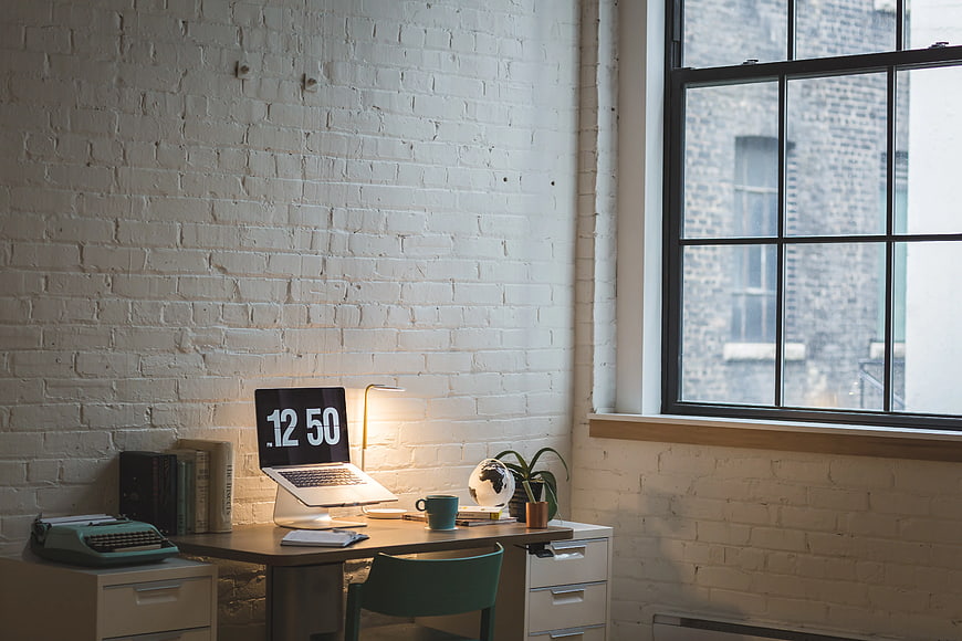 Modern Home Office Workspace with Laptop and Brick Wall