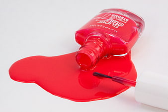 Spilled Red Nail Polish Bottle with Brush on White Background