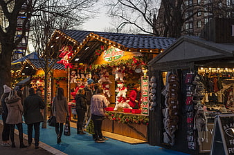 Busy Christmas Market Stall with Wooden Hut and Shoppers