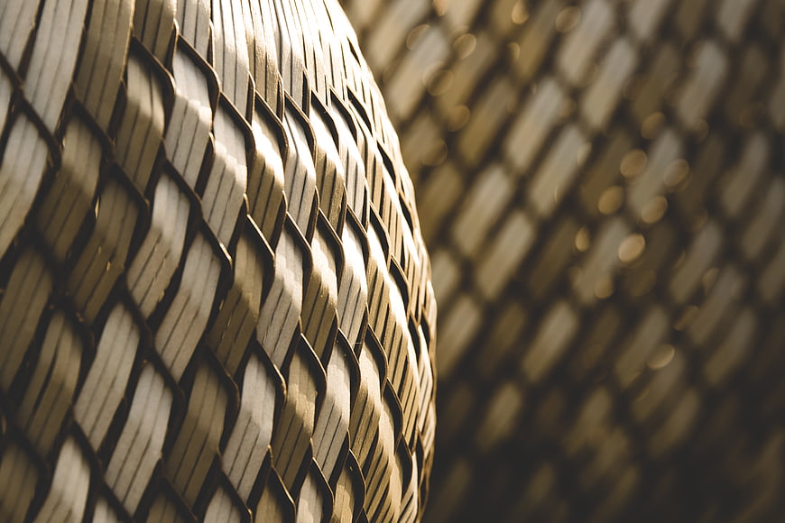 Close-up of textured woven rattan pattern with bokeh background