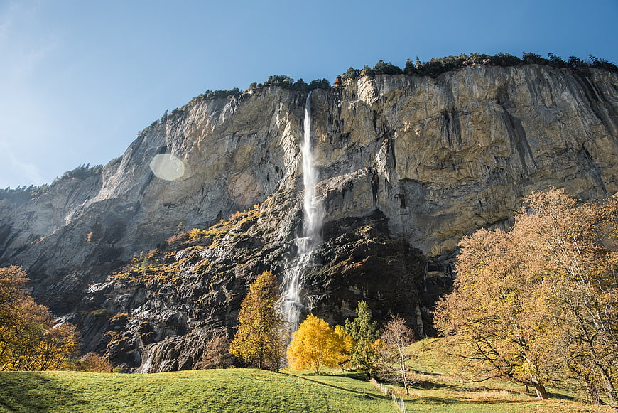Tall Mountain Waterfall in Autumn Landscape