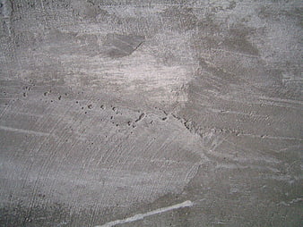Textured gray concrete wall background with industrial surface details