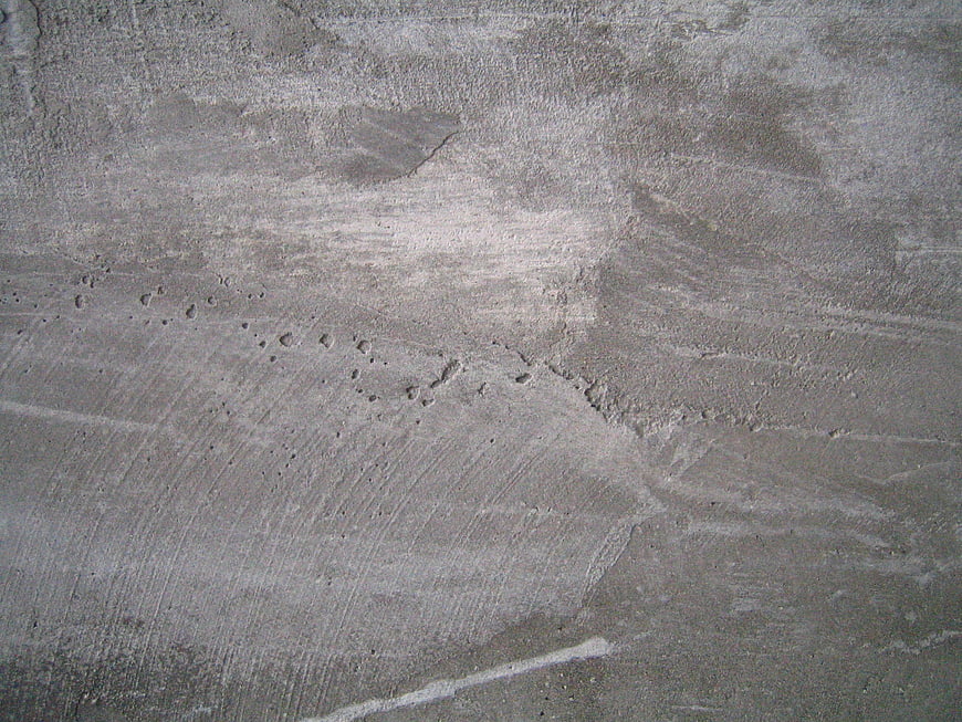 Textured gray concrete wall background with industrial surface details