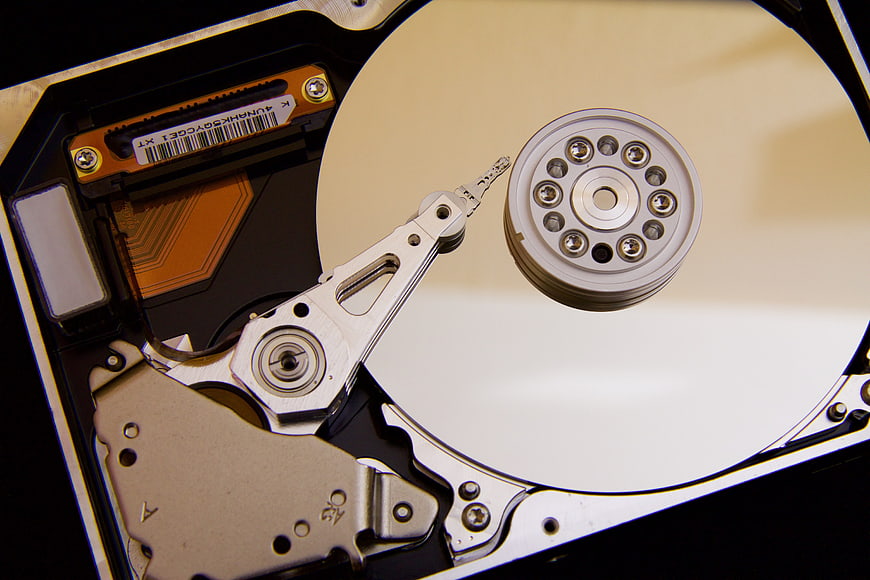 Close-up of open hard drive internal components and platter
