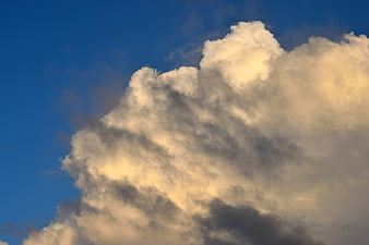 Dramatic Cumulus Clouds Against Deep Blue Sky