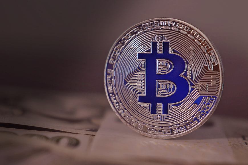 Physical Bitcoin Coin With Blue Symbol On Banknotes